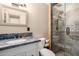 Tastefully renovated bathroom with a granite vanity, stone accent wall, and glass-enclosed shower at 1509 E Verlea Dr, Tempe, AZ 85282