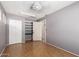 Neutral-toned bedroom with a closet, storage shelves, and a door to the bathroom at 1509 E Verlea Dr, Tempe, AZ 85282