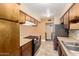 Traditional kitchen featuring tile floor, stainless steel appliances and matching wooden cabinets at 1509 E Verlea Dr, Tempe, AZ 85282