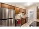 Efficient kitchen featuring stainless steel appliances, tile backsplash, and wood cabinets at 1509 E Verlea Dr, Tempe, AZ 85282