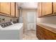 Bright laundry room with a washer, dryer, overhead cabinets, and tile floor at 1509 E Verlea Dr, Tempe, AZ 85282
