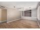 Spacious living room with wood floors, a ceiling fan, and custom built-in shelving at 1509 E Verlea Dr, Tempe, AZ 85282