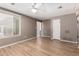 Bright living area with wood floors, a ceiling fan, and a large window for natural light at 1509 E Verlea Dr, Tempe, AZ 85282
