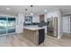Modern kitchen featuring white cabinets, stainless steel appliances, and a stylish center island at 1530 W Glenrosa Ave, Phoenix, AZ 85015