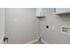 A clean laundry room boasts white cabinets and utility connections at 1530 W Glenrosa Ave, Phoenix, AZ 85015