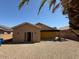 View of the home's backyard with a covered patio and gravel landscaping for easy maintenance at 15334 W Acapulco Ln, Surprise, AZ 85379