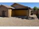 A view of the home's backyard and covered patio with gravel landscaping for easy maintenance at 15334 W Acapulco Ln, Surprise, AZ 85379