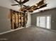 Bedroom featuring a ceiling fan, damaged ceiling and walls, and access to backyard at 15334 W Acapulco Ln, Surprise, AZ 85379