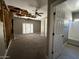 Bedroom featuring a ceiling fan, damaged ceiling and walls, and access to the bathroom at 15334 W Acapulco Ln, Surprise, AZ 85379