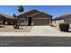 Charming single-story home with a desert landscape, a two-car garage and neutral-toned exterior paint at 15334 W Acapulco Ln, Surprise, AZ 85379