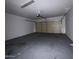 Empty garage with painted floor and closed door at 15334 W Acapulco Ln, Surprise, AZ 85379