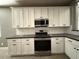 Kitchen showcases white cabinetry, modern appliances and a subway tile backsplash, blending style and functionality at 15334 W Acapulco Ln, Surprise, AZ 85379