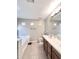 Bright bathroom with double sink vanity, bathtub, and separate toilet room at 16176 W Lisbon Ln, Surprise, AZ 85379