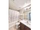 Cozy bathroom with a shower-tub combo, vanity with mirror, and ceramic tile flooring at 16176 W Lisbon Ln, Surprise, AZ 85379