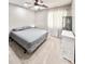 Bedroom with neutral carpet, ceiling fan, white trim, and a large window at 16176 W Lisbon Ln, Surprise, AZ 85379