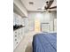 Bright bedroom featuring a ceiling fan, ensuite bathroom access, and neutral decor at 16176 W Lisbon Ln, Surprise, AZ 85379