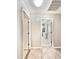 Hallway view featuring tile flooring leading to carpeted rooms and interior doors at 16176 W Lisbon Ln, Surprise, AZ 85379
