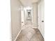 Hallway featuring tile floors and neutral colored walls leading to bedrooms at 16176 W Lisbon Ln, Surprise, AZ 85379