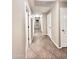 Hallway with tile flooring, neutral walls, and white doors creates a bright and clean aesthetic at 16176 W Lisbon Ln, Surprise, AZ 85379