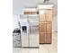 Stainless steel refrigerator and wood cabinets offer ample storage in this kitchen at 16176 W Lisbon Ln, Surprise, AZ 85379