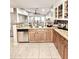Functional kitchen with granite counters, tiled backsplash, stainless steel appliances, and tile flooring at 16176 W Lisbon Ln, Surprise, AZ 85379