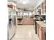This kitchen features stainless steel appliances, granite countertops, and wood cabinets at 16176 W Lisbon Ln, Surprise, AZ 85379