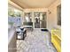 Covered outdoor patio with tiled floor, seating, and outdoor furniture at 16176 W Lisbon Ln, Surprise, AZ 85379