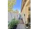 This side yard features block fencing, potted plants and gravel at 16176 W Lisbon Ln, Surprise, AZ 85379