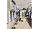 Organized walk-in closet with clothes and shoes on racks at 16176 W Lisbon Ln, Surprise, AZ 85379