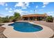 A beautiful backyard with a sparkling pool, desert landscaping, and a spacious home with ample windows at 16927 E Trojan Ct, Fountain Hills, AZ 85268