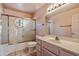 Cozy bathroom featuring a shower-tub combo with a decorative glass partition and a single sink vanity at 16927 E Trojan Ct, Fountain Hills, AZ 85268