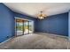 Blue bedroom with plush carpeting and sliding glass doors to the pool area at 16927 E Trojan Ct, Fountain Hills, AZ 85268