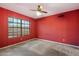 Red secondary bedroom featuring a ceiling fan and large windows offering lots of light at 16927 E Trojan Ct, Fountain Hills, AZ 85268