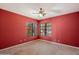 Red secondary bedroom featuring a ceiling fan and large windows offering lots of light at 16927 E Trojan Ct, Fountain Hills, AZ 85268
