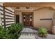 Inviting front entrance with wooden door, trellis, desert landscaping and decorative windows at 16927 E Trojan Ct, Fountain Hills, AZ 85268