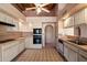 Traditional kitchen with white cabinets, neutral tile flooring, and modern appliances at 16927 E Trojan Ct, Fountain Hills, AZ 85268