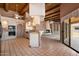 Open kitchen with breakfast bar, white cabinets, tile floors, and views to a living area at 16927 E Trojan Ct, Fountain Hills, AZ 85268