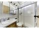 Bathroom featuring a sink with cabinet, mirror, toilet, and walk-in shower at 17200 W Bell Rd # 812, Surprise, AZ 85374
