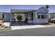 Charming mobile home featuring covered parking, a neatly landscaped yard, and a welcoming entrance at 17200 W Bell Rd # 812, Surprise, AZ 85374