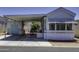 Charming mobile home exterior showcasing a covered parking area and a well-maintained front entrance at 17200 W Bell Rd # 812, Surprise, AZ 85374