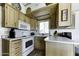 Cozy kitchen featuring light wood cabinets, white appliances, and ample counter space for meal preparation at 17200 W Bell Rd # 812, Surprise, AZ 85374