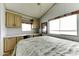 Bedroom featuring a full bed, built-in dresser with cabinets, and a bright window at 17200 W Bell Rd # 812, Surprise, AZ 85374