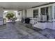Spacious covered patio with a dining set, steps to the home, and ample room for outdoor living at 17200 W Bell Rd # 812, Surprise, AZ 85374