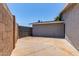 This view of the backyard shows the wall separating the yard from the adjacent property at 17401 N 16Th Ave, Phoenix, AZ 85023