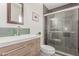 Updated bathroom features gray tiled shower and modern vanity with green backsplash tile at 17401 N 16Th Ave, Phoenix, AZ 85023