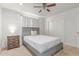 Cozy bedroom has white brick accent wall, white bedding, and wooden furniture accents at 17401 N 16Th Ave, Phoenix, AZ 85023