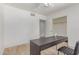 This bright bedroom has wood floors, closet, ceiling fan, and is staged with a modern desk at 17401 N 16Th Ave, Phoenix, AZ 85023