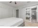 Bright bedroom featuring mirrored sliding door to the bathroom, white walls, and light carpet at 17401 N 16Th Ave, Phoenix, AZ 85023