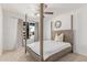 Bright bedroom featuring white walls, four poster bed, and large window allowing natural light at 17401 N 16Th Ave, Phoenix, AZ 85023