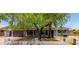 Charming single-story home featuring mature trees, a brick facade, and an attached garage at 17401 N 16Th Ave, Phoenix, AZ 85023